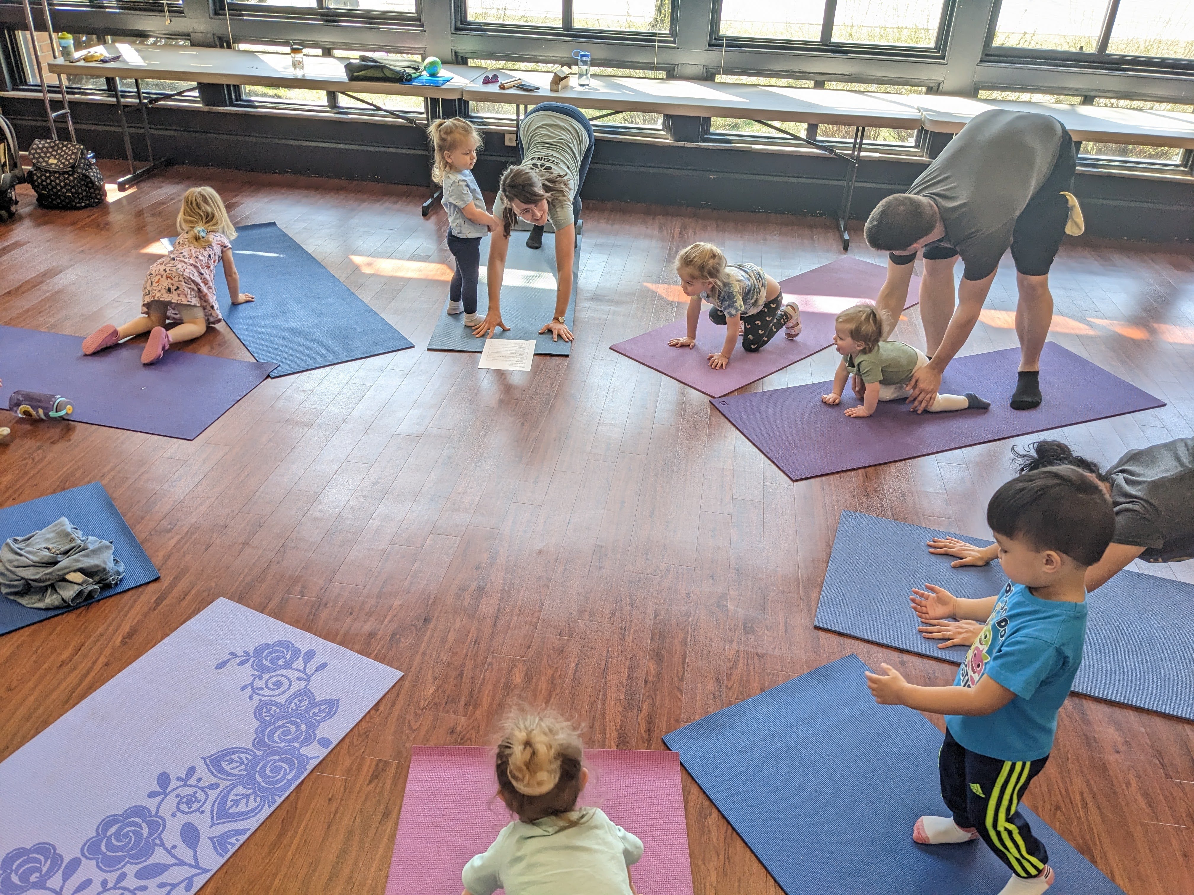 A group of adults and children on yoga mats